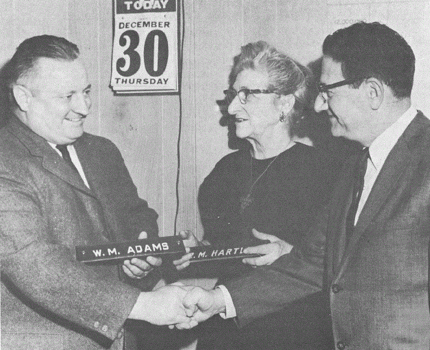 Rachel Hartley and fellow selectman William Adams turn in their nameplates to the first mayor, John DeNicola, Sr.